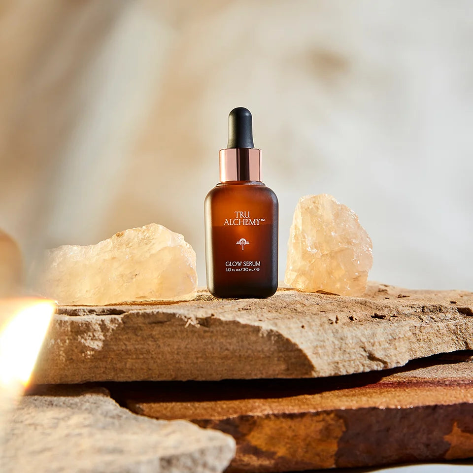 Tru Alchemy's Glow Serum between two crystals