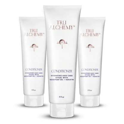 TruAlchemy Conditioner tubes with rosemary oil and keratin, featuring one larger center bottle flanked by two smaller bottles