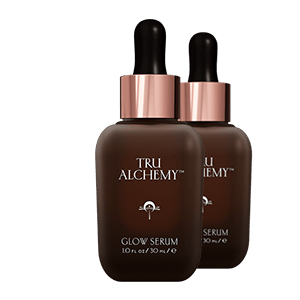TruAlchemy Glow Serum two-piece set with rose gold dropper caps and dark glass bottles
